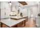 Stylish kitchen with island, marble countertops, custom cabinetry, and modern lighting at 157 Silver Falls Dr, Troutman, NC 28166