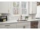 Kitchen sink and countertop with ample light and stainless steel dishwasher at 157 Silver Falls Dr, Troutman, NC 28166
