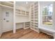 Functional laundry room with custom shelves, a built-in desk, and natural light at 157 Silver Falls Dr, Troutman, NC 28166