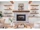 Inviting living room with stone fireplace, wooden beams, and stylish decor at 157 Silver Falls Dr, Troutman, NC 28166