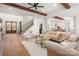 Open-concept living room with staircase, hardwood floors, and seamless flow to the kitchen at 157 Silver Falls Dr, Troutman, NC 28166