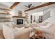 Bright living room featuring a stone fireplace, wood beams, and comfortable seating at 157 Silver Falls Dr, Troutman, NC 28166