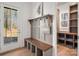 A well-organized mudroom features a bench, coat hooks, and stylish storage solutions with natural light from the front door at 157 Silver Falls Dr, Troutman, NC 28166