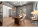Well-lit office with wood floors, paneled walls, a modern chandelier, and a spacious layout at 157 Silver Falls Dr, Troutman, NC 28166