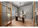 Stylish home office features wood floors, modern lighting, paneled walls, and large windows at 157 Silver Falls Dr, Troutman, NC 28166