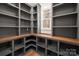 Spacious walk-in pantry with custom shelving, metal storage baskets, and wood countertop at 157 Silver Falls Dr, Troutman, NC 28166