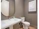 Stylish powder room featuring modern fixtures, a decorative mirror, and elegant artwork at 157 Silver Falls Dr, Troutman, NC 28166