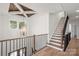 Bright staircase with dark iron railings and a unique lighting fixture at 157 Silver Falls Dr, Troutman, NC 28166