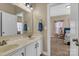 Double sink bathroom with lots of lighting and mirror, with access to the Primary bedroom at 1857 Felts Pkwy, Fort Mill, SC 29715