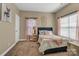 Cozy bedroom featuring a comfy bed, bedside table, and soft natural light from two windows at 1857 Felts Pkwy, Fort Mill, SC 29715