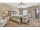 Bright bedroom features a decorative headboard, ceiling fan, bedside tables, and lots of natural light at 1857 Felts Pkwy, Fort Mill, SC 29715