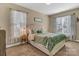 A cozy bedroom with natural light, complemented by soft carpeting and tasteful decor, makes for a serene retreat at 1857 Felts Pkwy, Fort Mill, SC 29715
