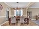 Bright dining room featuring a modern light fixture and seating for six at 1857 Felts Pkwy, Fort Mill, SC 29715