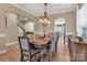 Open dining room with modern light fixture, seating for six, and neutral wall colors at 1857 Felts Pkwy, Fort Mill, SC 29715
