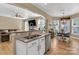Open kitchen with stainless appliances overlooks the breakfast nook and living room for a seamless entertaining experience at 1857 Felts Pkwy, Fort Mill, SC 29715