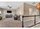 Upstairs living room boasts a cozy seating area, television, and neutral color palette, ideal for relaxation at 1857 Felts Pkwy, Fort Mill, SC 29715