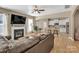Open-concept living room with fireplace, hardwood floors, and kitchen access at 1857 Felts Pkwy, Fort Mill, SC 29715