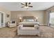 Large main bedroom suite with a sitting area with abundant natural light and comfortable furnishings provides a peaceful oasis at 1857 Felts Pkwy, Fort Mill, SC 29715