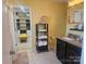 Well-lit bathroom showcases walk-in closet, vanity with granite countertop and storage at 190 Glastonbury Dr, Mooresville, NC 28115
