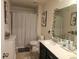 Cozy bathroom features neutral colors, vanity and a shower with patterned curtain at 190 Glastonbury Dr, Mooresville, NC 28115