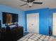 Contemporary bedroom featuring blue walls, fan and dark wood dresser at 190 Glastonbury Dr, Mooresville, NC 28115