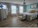 Bright bedroom featuring hardwood floors, neutral walls, ceiling fan, and decor pieces at 190 Glastonbury Dr, Mooresville, NC 28115