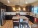 Modern kitchen featuring granite countertops, stainless steel appliances, dark wood cabinets, and a center island at 190 Glastonbury Dr, Mooresville, NC 28115
