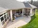 Aerial shot of the home's backyard, with a covered patio, manicured lawn, and beautifully landscaped garden at 2011 Trailwood Dr, Matthews, NC 28104
