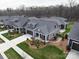 Aerial view of the gray home showcasing the meticulously landscaped yard and neighborhood at 2011 Trailwood Dr, Matthews, NC 28104