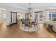 Bright dining room features a modern chandelier and sliding doors to the living room and outdoor patio at 2011 Trailwood Dr, Matthews, NC 28104