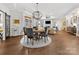Elegant dining area with a chandelier, hardwood floors, and open layout connecting to the living room for easy entertaining at 2011 Trailwood Dr, Matthews, NC 28104