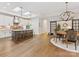 Open-concept kitchen featuring stainless steel appliances, island seating, and hardwood floors, perfect for entertaining at 2011 Trailwood Dr, Matthews, NC 28104