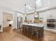 Well-lit kitchen with skylights, a spacious island with seating, and modern stainless steel appliances at 2011 Trailwood Dr, Matthews, NC 28104