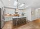 Bright and airy kitchen featuring skylights, a central island with seating, and ample cabinet space at 2011 Trailwood Dr, Matthews, NC 28104
