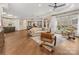 Spacious living room with hardwood floors, an open layout, and large windows offering abundant natural light at 2011 Trailwood Dr, Matthews, NC 28104