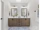 Well-lit bathroom with dual sinks, modern fixtures, and a clean, elegant design at 2011 Trailwood Dr, Matthews, NC 28104