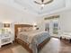 Spacious main bedroom with decorative ceiling, ceiling fan, door to backyard, and stylish decor at 2011 Trailwood Dr, Matthews, NC 28104