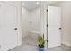 Beautiful tiled shower stall with built-in bench and decorative mosaic flooring at 2011 Trailwood Dr, Matthews, NC 28104