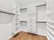 Walk-in closet featuring custom shelving, hanging rods, and built-in drawers for optimal storage at 2011 Trailwood Dr, Matthews, NC 28104