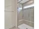 Modern bathroom featuring a glass shower with bench, gray tiling, and recessed window at 2149 Bexar Trl, Matthews, NC 28105