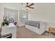 Bright bedroom featuring two windows, ceiling fan, desk, and a bed with storage drawers at 2149 Bexar Trl, Matthews, NC 28105