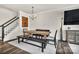 Bright dining area with a wooden table, bench, and modern chandelier fixture at 2149 Bexar Trl, Matthews, NC 28105