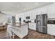 Contemporary kitchen boasts white cabinets, stainless steel appliances, granite counters, and an open layout at 2149 Bexar Trl, Matthews, NC 28105