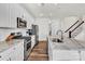 Well-equipped kitchen featuring white cabinets, granite countertops, stainless steel appliances, and a functional island at 2149 Bexar Trl, Matthews, NC 28105