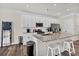 Modern kitchen featuring white cabinetry, granite countertops, stainless steel appliances and a large island with bar seating at 2149 Bexar Trl, Matthews, NC 28105