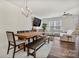 Open-concept living area with a modern sofa, dining area, and ceiling fan at 2149 Bexar Trl, Matthews, NC 28105