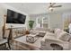 Comfortable living room featuring a large sofa, TV, and modern decor at 2149 Bexar Trl, Matthews, NC 28105