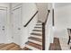 Staircase with carpeted steps, white risers, and dark wood railings at 2149 Bexar Trl, Matthews, NC 28105