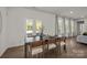 Sunlit dining room with a dark wood table, seating for six, and views to the backyard at 261 Supernova Dr, York, SC 29745