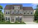 Charming two-story home featuring a well-maintained lawn and a welcoming front porch with columns at 261 Supernova Dr, York, SC 29745